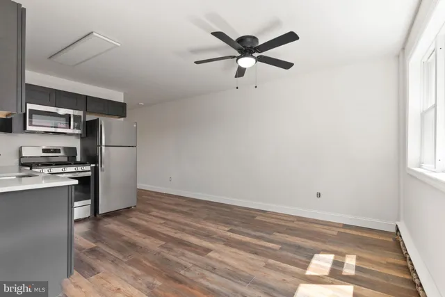 a view of a kitchen with a sink dishwasher and wooden floor