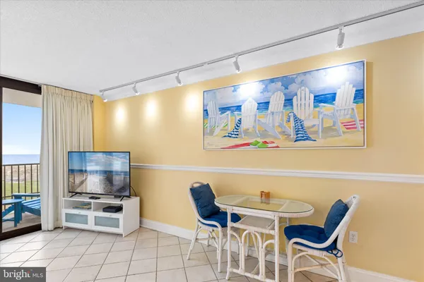 a kitchen with stainless steel appliances a stove a dining table and chairs