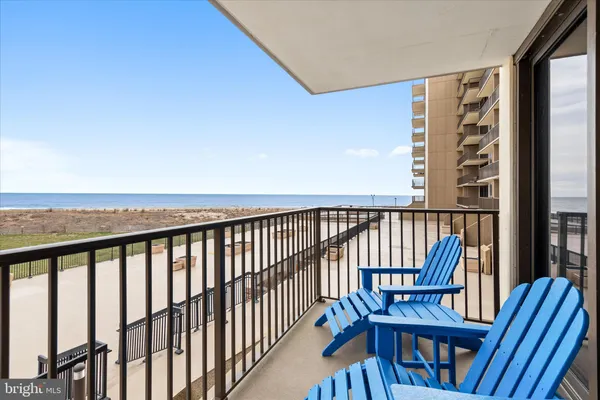 a view of a balcony with wooden floor and outdoor seating