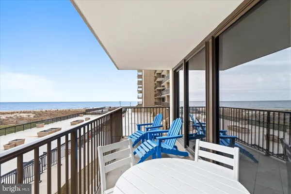 a view of a balcony with chairs and wooden floor