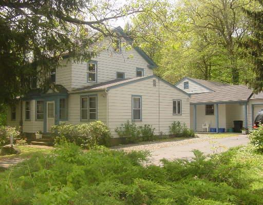 33 Booth Hill Road Trumbull, CT 06611 - Photo 1 of 1 a front view of a house with a yard and potted plants