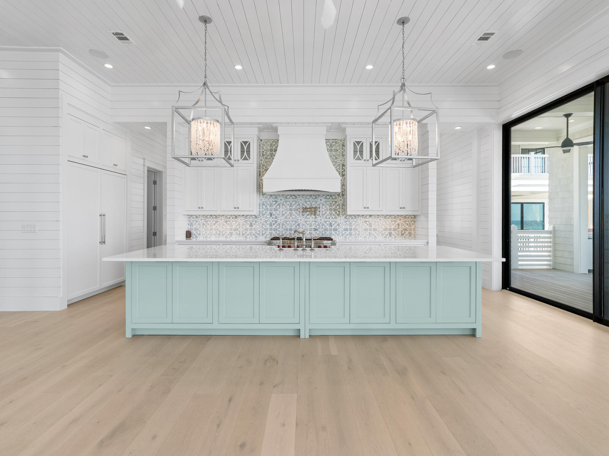264 Grace Pt Way Watersound, FL 32461 - Photo 9 of 69 a kitchen with kitchen island granite countertop a sink a stove and cabinets