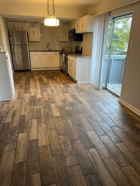 5603 Harvest Hill Road, Unit 2003 Dallas, TX 75230 - Photo 4 of 11 a kitchen with granite countertop a stove a sink and a refrigerator