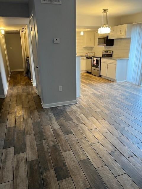 5603 Harvest Hill Road, Unit 2003 Dallas, TX 75230 - Photo 5 of 11 a view of a kitchen with kitchen island wooden floor and stainless steel appliances