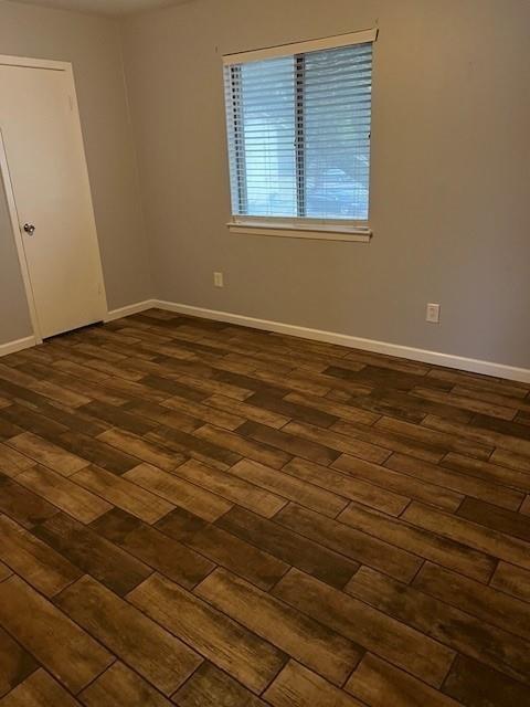 5603 Harvest Hill Road, Unit 2003 Dallas, TX 75230 - Photo 6 of 11 an empty room with wooden floor and windows