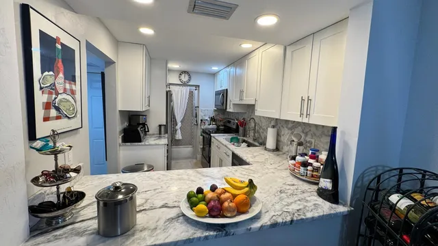 a kitchen with sink refrigerator and stove