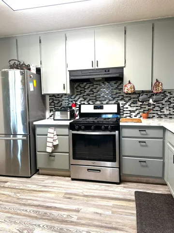 a kitchen with a stove and a refrigerator