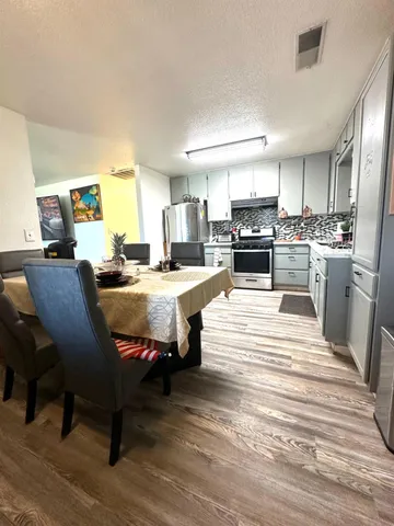 a large kitchen with a table and chairs