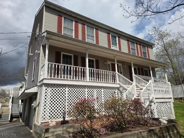 a front view of house with yard and outdoor seating