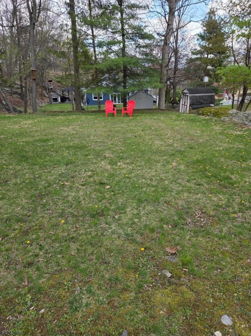 8 Papoose Trail Hopatcong, NJ 07821 - Photo 23 of 38 a view of a white house with a big yard and large trees