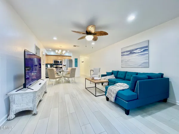 a living room with furniture and a chandelier