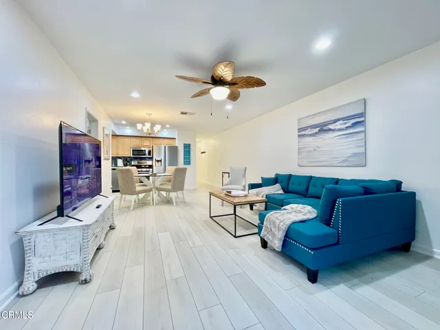 a living room with furniture and a chandelier
