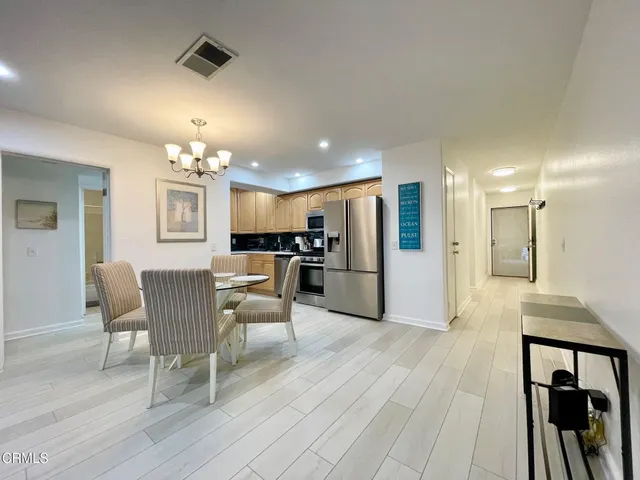 a dining room with furniture and kitchen view