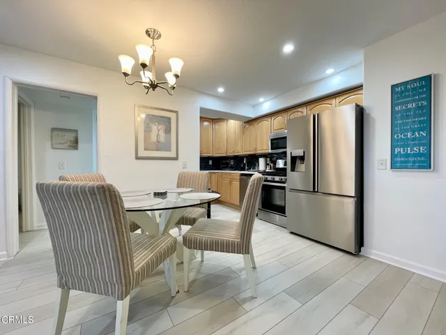 a view of a dining room with furniture and a chandelier