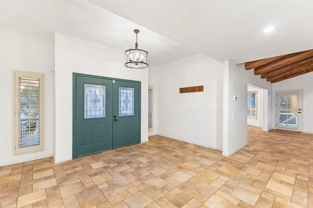 a view of an entryway with workspace and windows