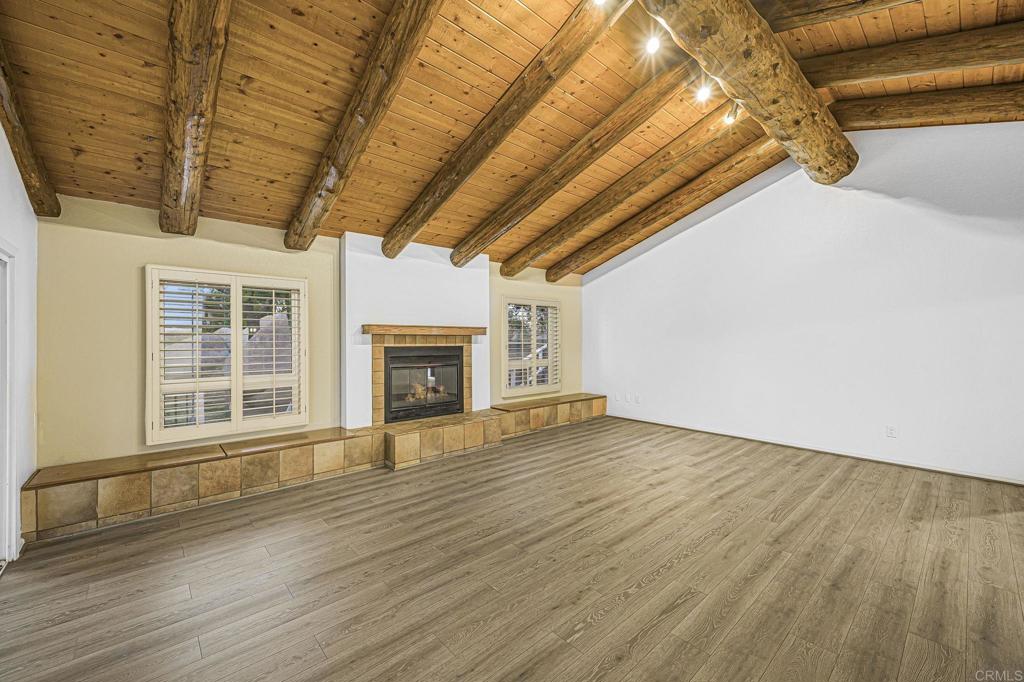 28720 Sandhurst Way Escondido, CA 92026 - Photo 18 of 57 a view of an empty room with wooden floor and a window