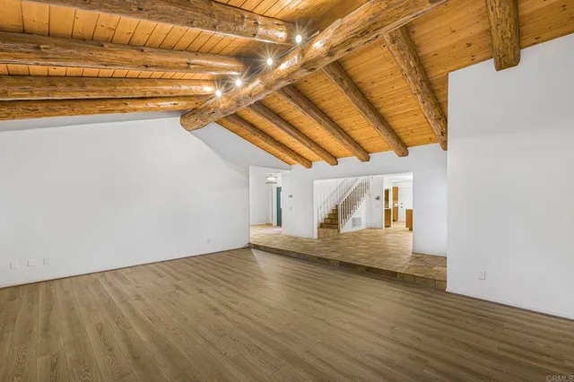 a view of an empty room with a fireplace and a window