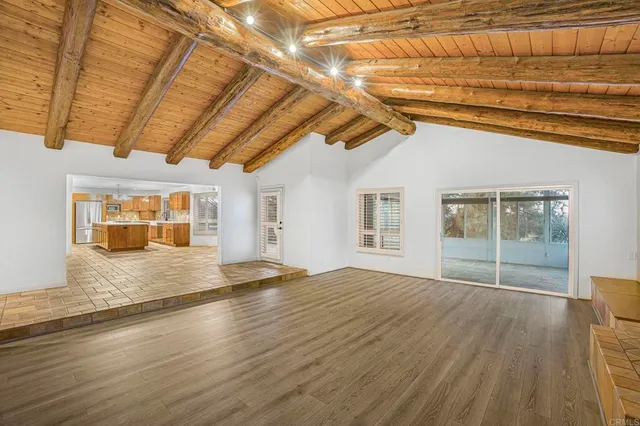 a large white kitchen with cabinets