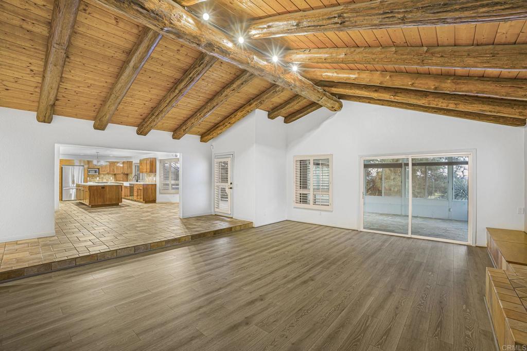 28720 Sandhurst Way Escondido, CA 92026 - Photo 20 of 57 a view of an empty room with wooden floor and a window