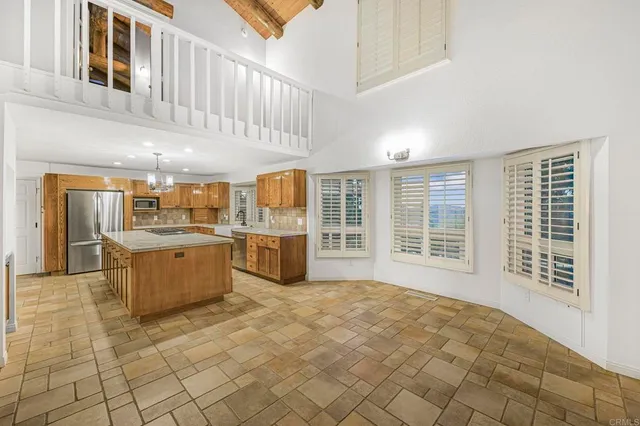an open kitchen with a sink and large window