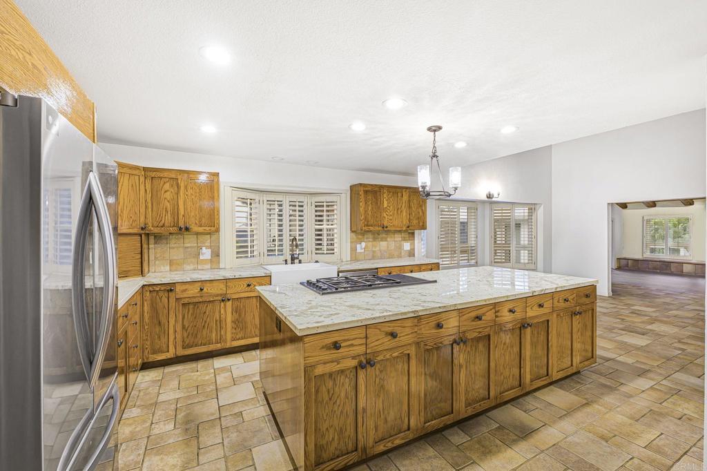 28720 Sandhurst Way Escondido, CA 92026 - Photo 27 of 57 a spacious bathroom with a granite countertop tub sink and mirror