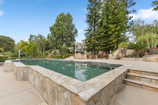 a view of a swimming pool with a patio