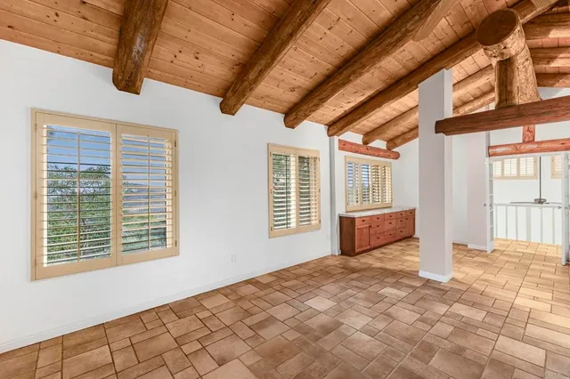 a bathroom with a granite countertop sink and large window