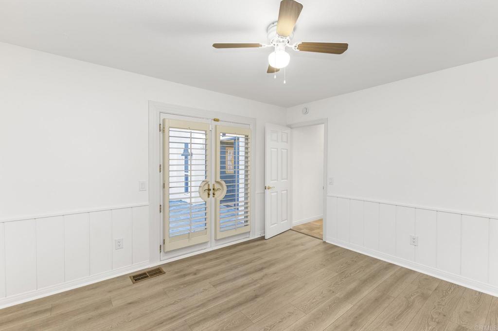 28720 Sandhurst Way Escondido, CA 92026 - Photo 42 of 57 an empty room with wooden floor fan and windows