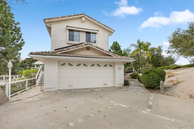 a pathway of a house with a yard
