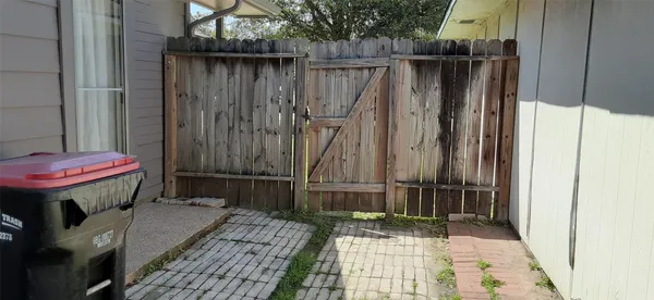 a view of backyard with wooden fences