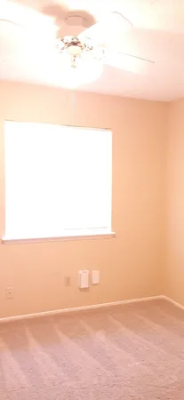 a view of an empty room with a fan