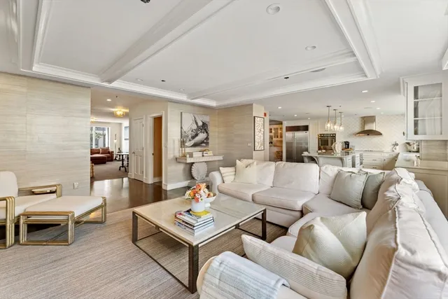 a living room with furniture a wooden floor and a sink