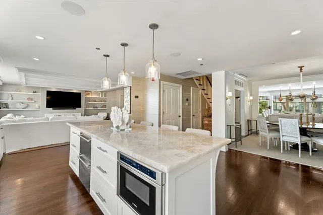 a kitchen with a stove and a wooden floor