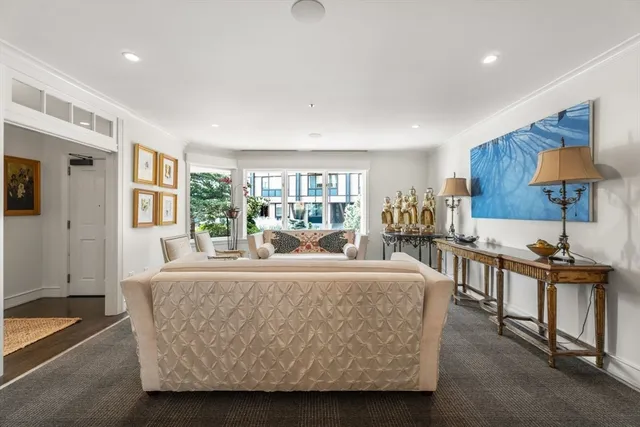 a living room with furniture and a lamp