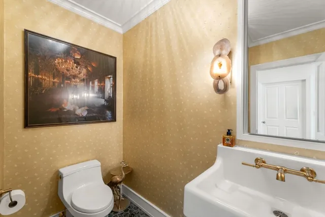 a bathroom with a toilet a sink and mirror