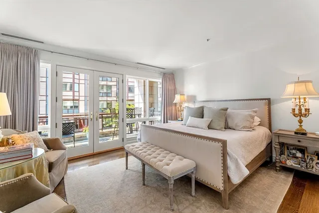 a spacious bedroom with a bed and wooden floor