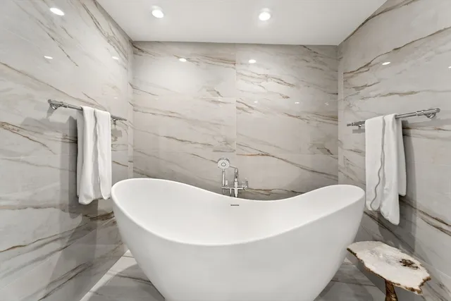 a white bath tub sitting in a bathroom