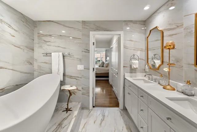 a bathroom with a double vanity sink a mirror and a shower