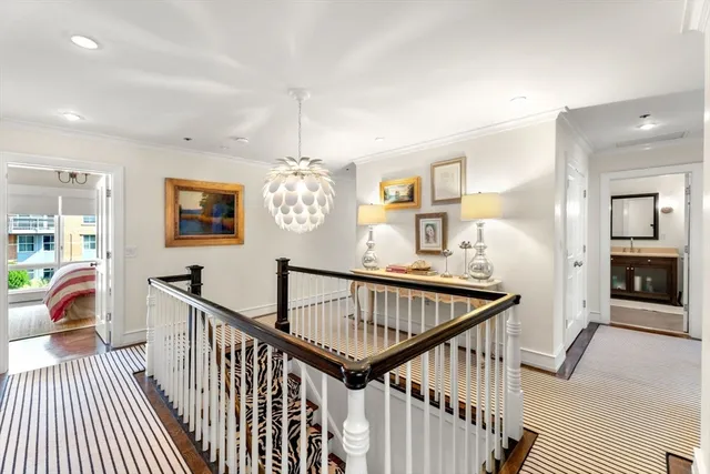 a view of a livingroom with furniture hardwood floor and hallway