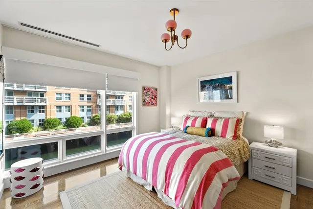 a bedroom with a bed and a large window