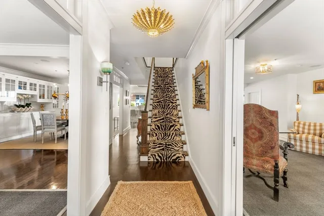 a view of a hallway with wooden floor and entryway