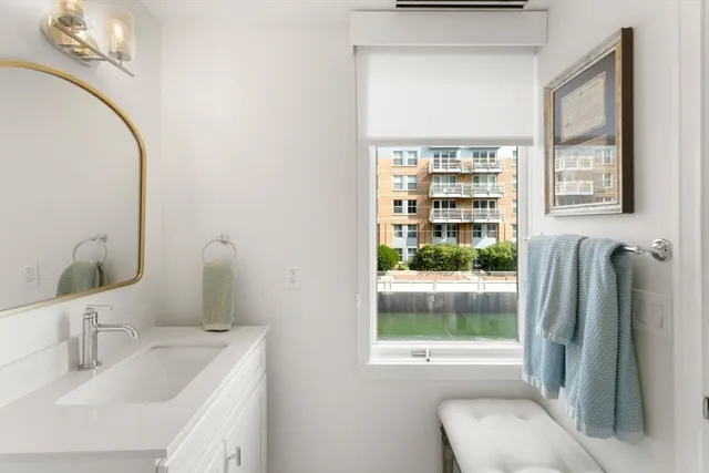 a bathroom with a sink a toilet and a mirror