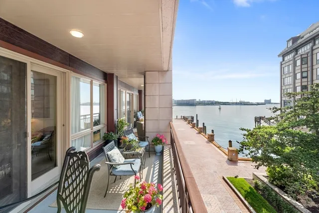 a balcony with furniture and a potted plant