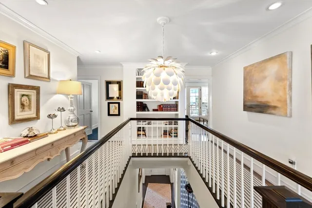 a view of a hallway with wooden floor and staircase