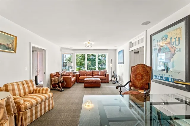 a living room with furniture and large windows