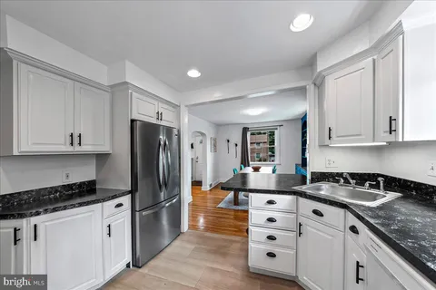 a kitchen with appliances a sink and cabinets