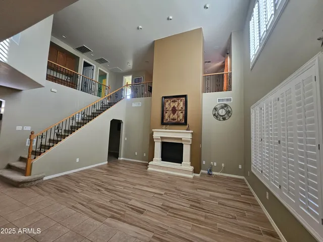a view of a livingroom with wooden floor and staircase