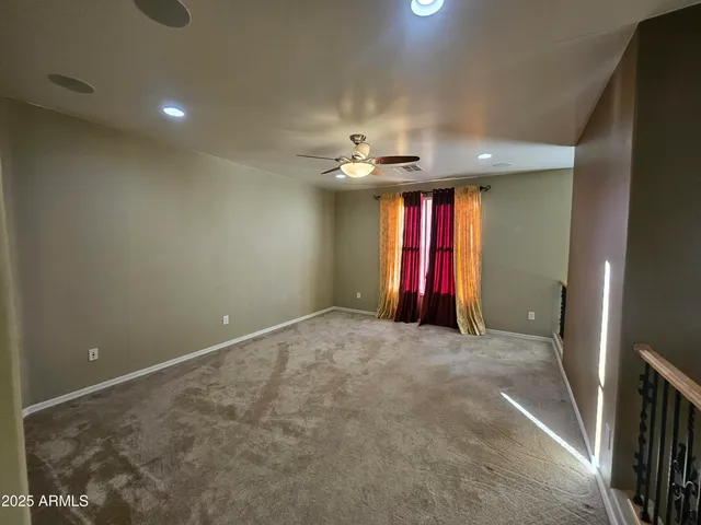 en view of a livingroom with a ceiling fan