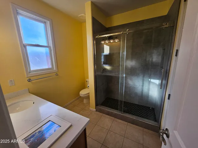 a kitchen with a sink a stove top oven and cabinetry