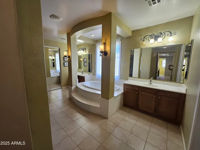a bathroom with a glass shower door and a mirror